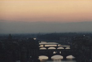 The city and the bridges over the river Arno at sunset